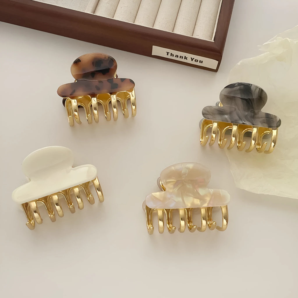 Acetate hair barrettes with metal grip closure in leopard print, beige, white and ink colours