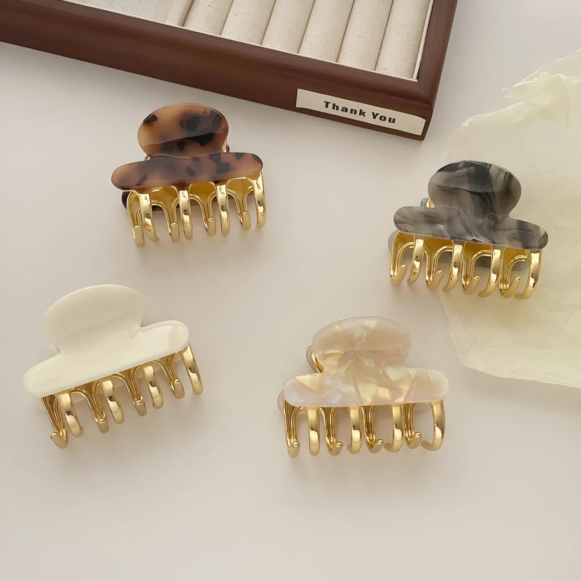 Acetate hair barrettes with metal grip closure in leopard print, beige, white and ink colours