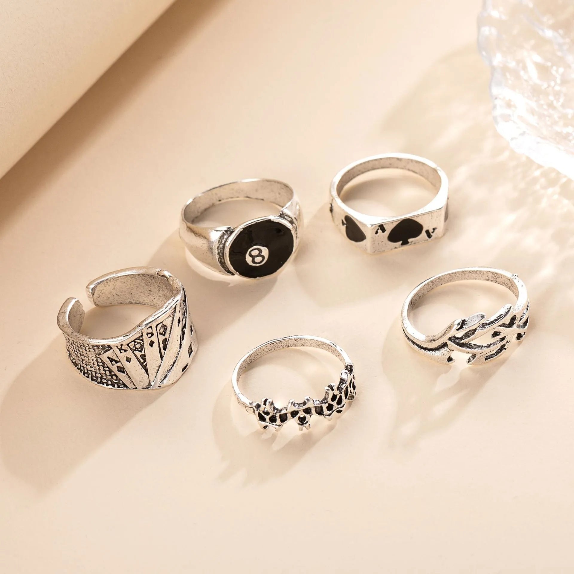 Black alloy fashion ring with a raised retro poker card spade design on a finger.