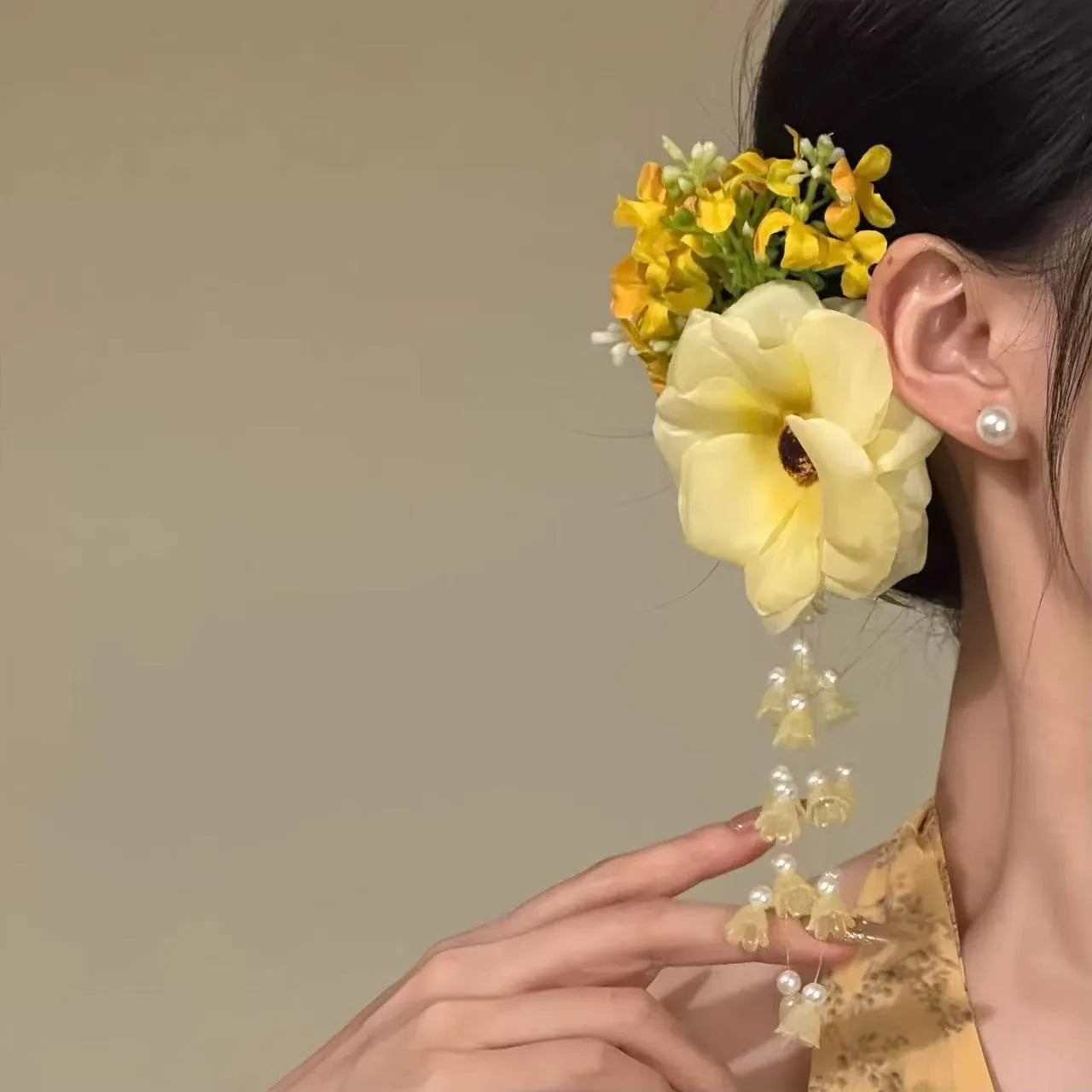 Yellow and purple floral tassel side clip hair accessory for women.