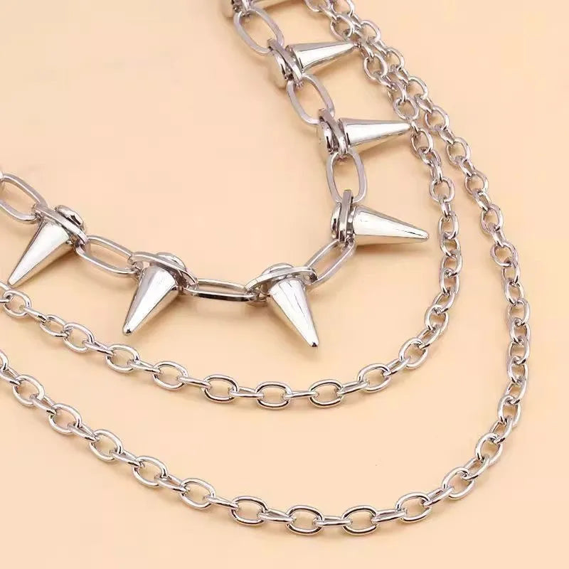 Silver metal double layer pants chain with rivet ornaments on dark trousers