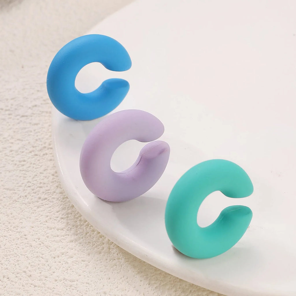 C-shaped geometric clip-on earrings in matte coarse texture with 15 candy colour options including yellow, cyan, purple and pink