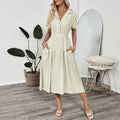 Light green women's twill shirt dress with lapel collar, adjustable waist belt, and splicing detail