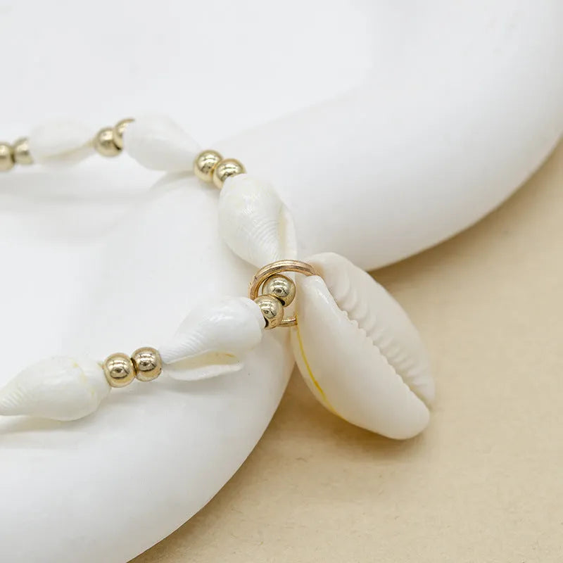 White conch shell necklace for women with a mother of pearl pendant on a regular chain.