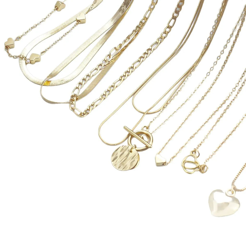 Set of 10 gold women's necklaces with adjustable chains and alloy pendants displayed in gift packaging
