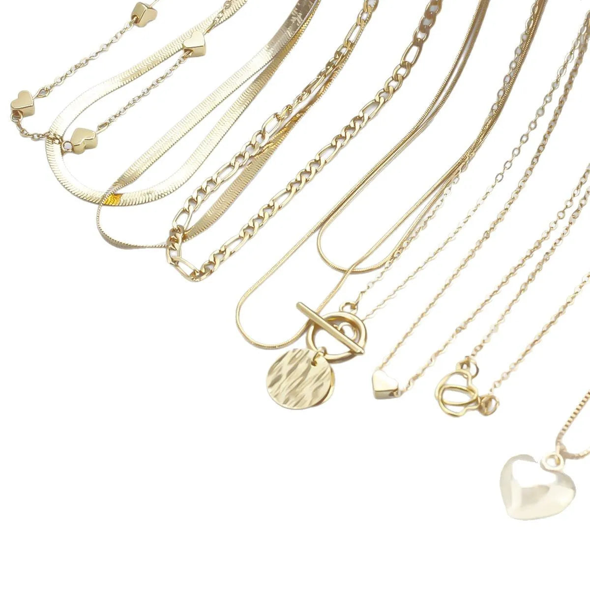 Set of 10 gold women's necklaces with adjustable chains and alloy pendants displayed in gift packaging