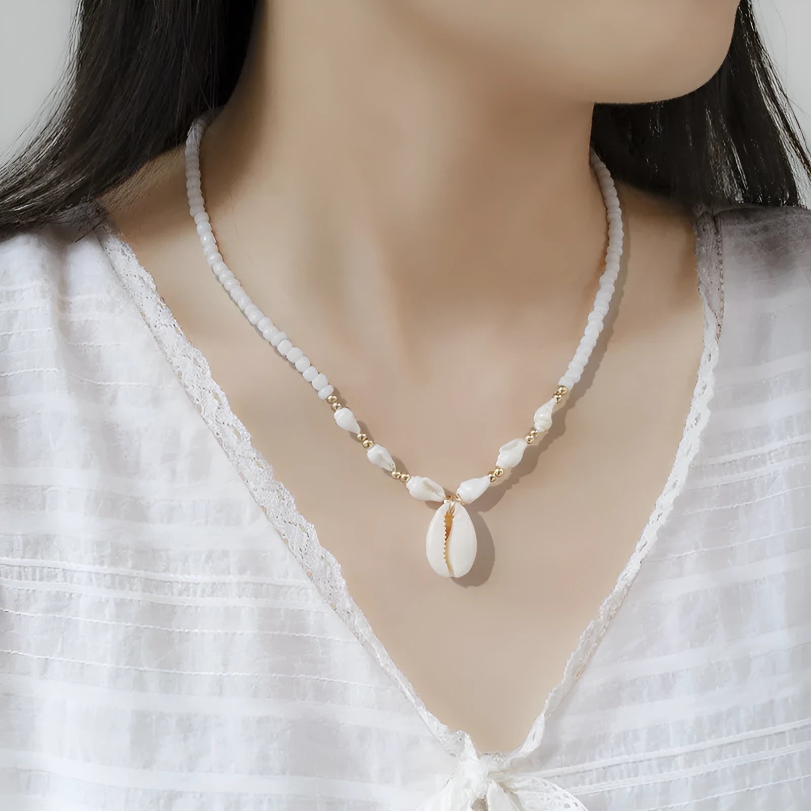 White conch shell necklace for women with a mother of pearl pendant on a regular chain.