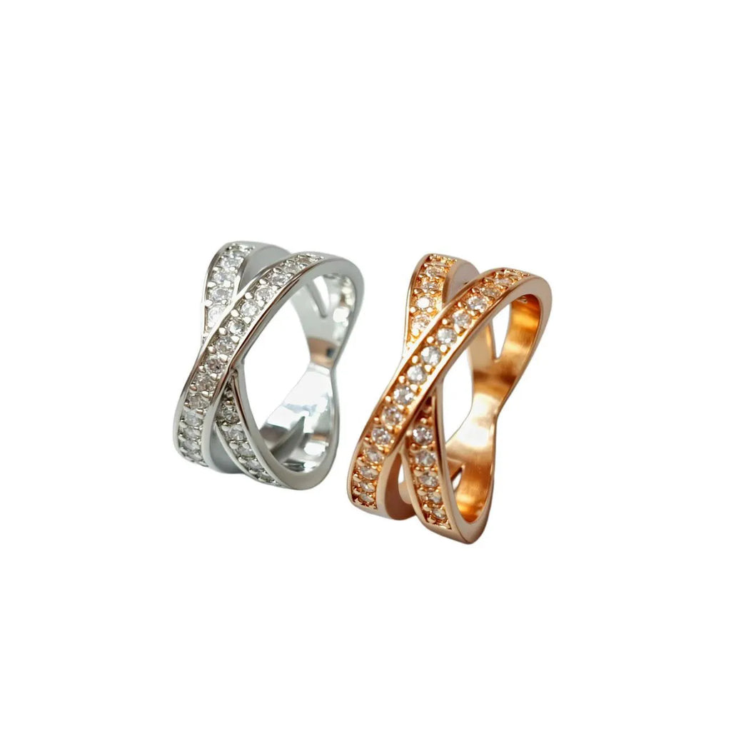Geometric cross design ring with micro-inlaid zircon on a copper band, shown in silver and rose gold finishes.