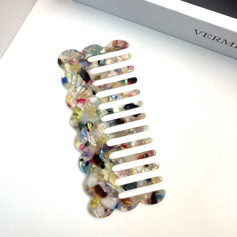 Acetate board geometric wave hairdressing comb for women in pink colour, showing wave shape and lightweight construction