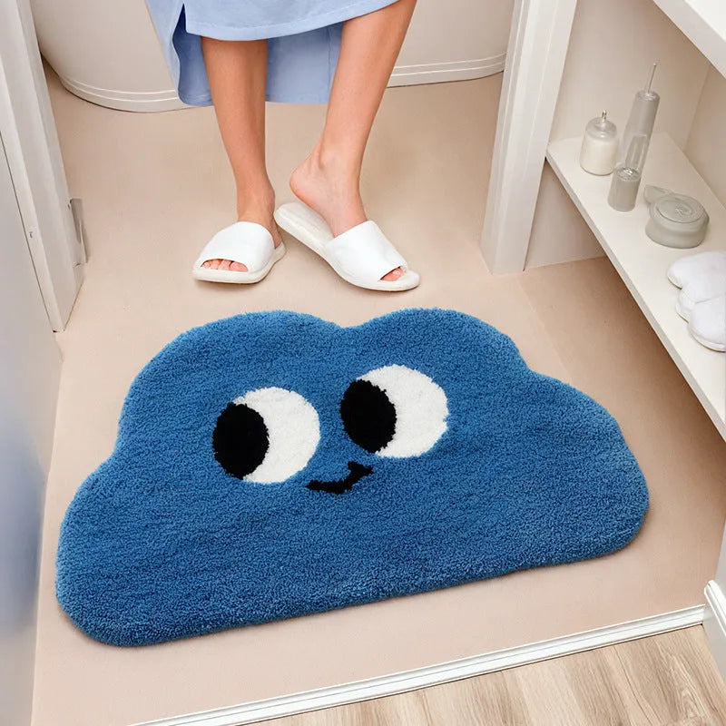 Cartoon anime character printed bathroom mat in green, blue, pink, black, or white, available in three sizes.