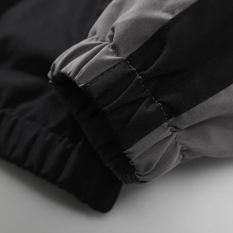 Men's black polyester jacket with contrast stitching and side seam pockets on a model