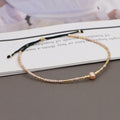 Women's handmade Bohemian bracelet with colourful glass beads in geometric shapes on a wrist.
