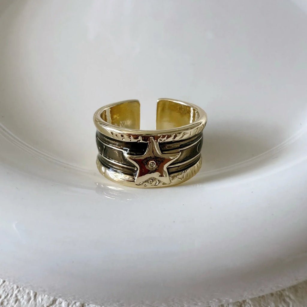 Adjustable geometric copper ring with a distressed electroplated finish in a choice of colours.