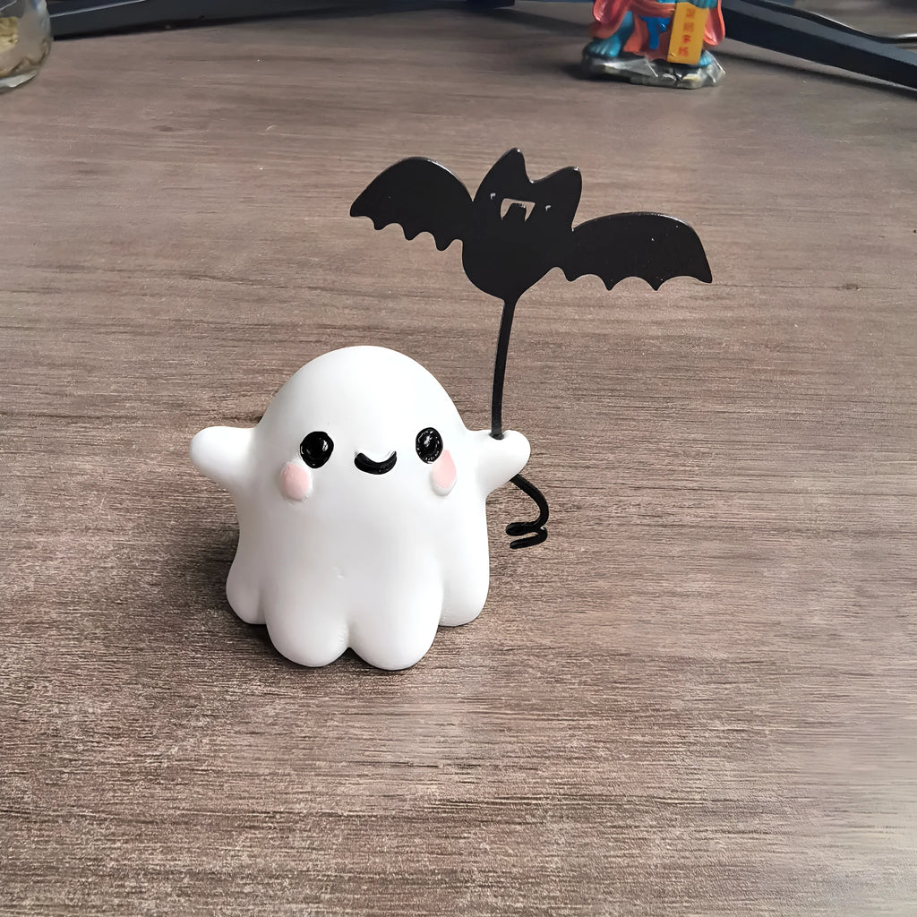 Small hand-painted resin statue of a ghost walking a dog and holding a bat, a miniature Halloween ornament.