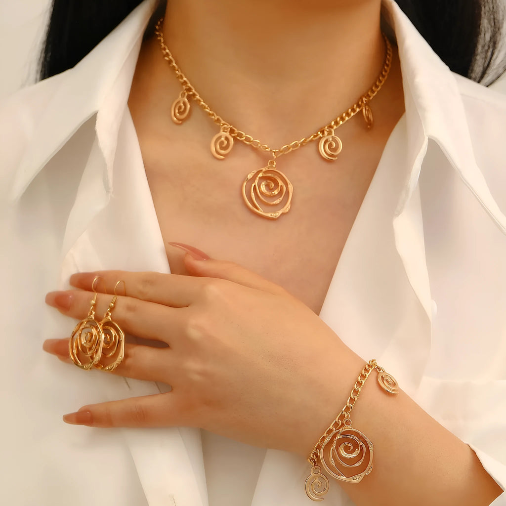 Spiral donut jewellery set showing necklace, bracelet and ear hooks in gold or silver geometric circle design