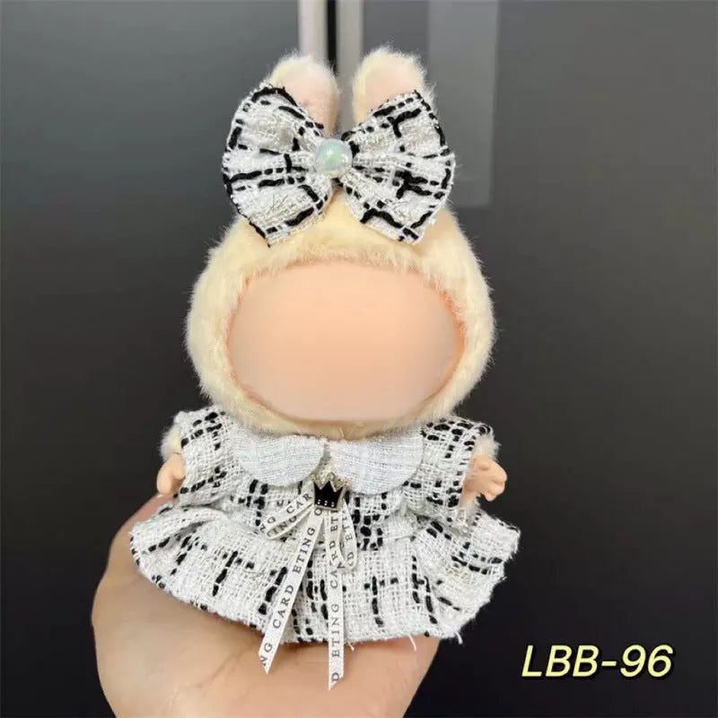 Plastic doll costume outfit designed for 17cm tall vinyl figurines on a display stand.