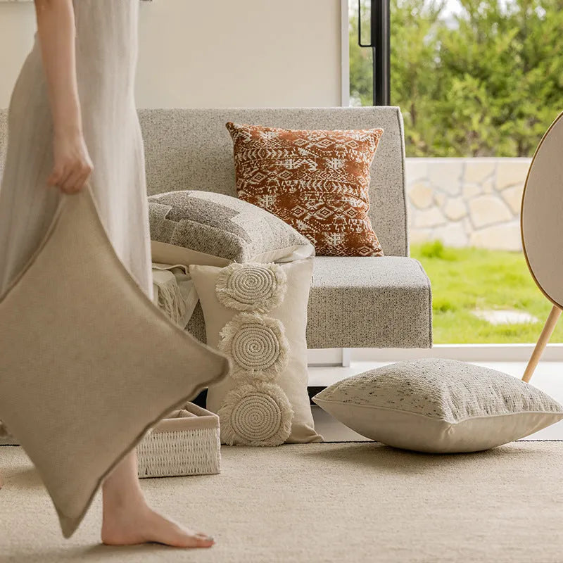Solid colour rectangular and square sofa cushions with removable covers on a bay window seat