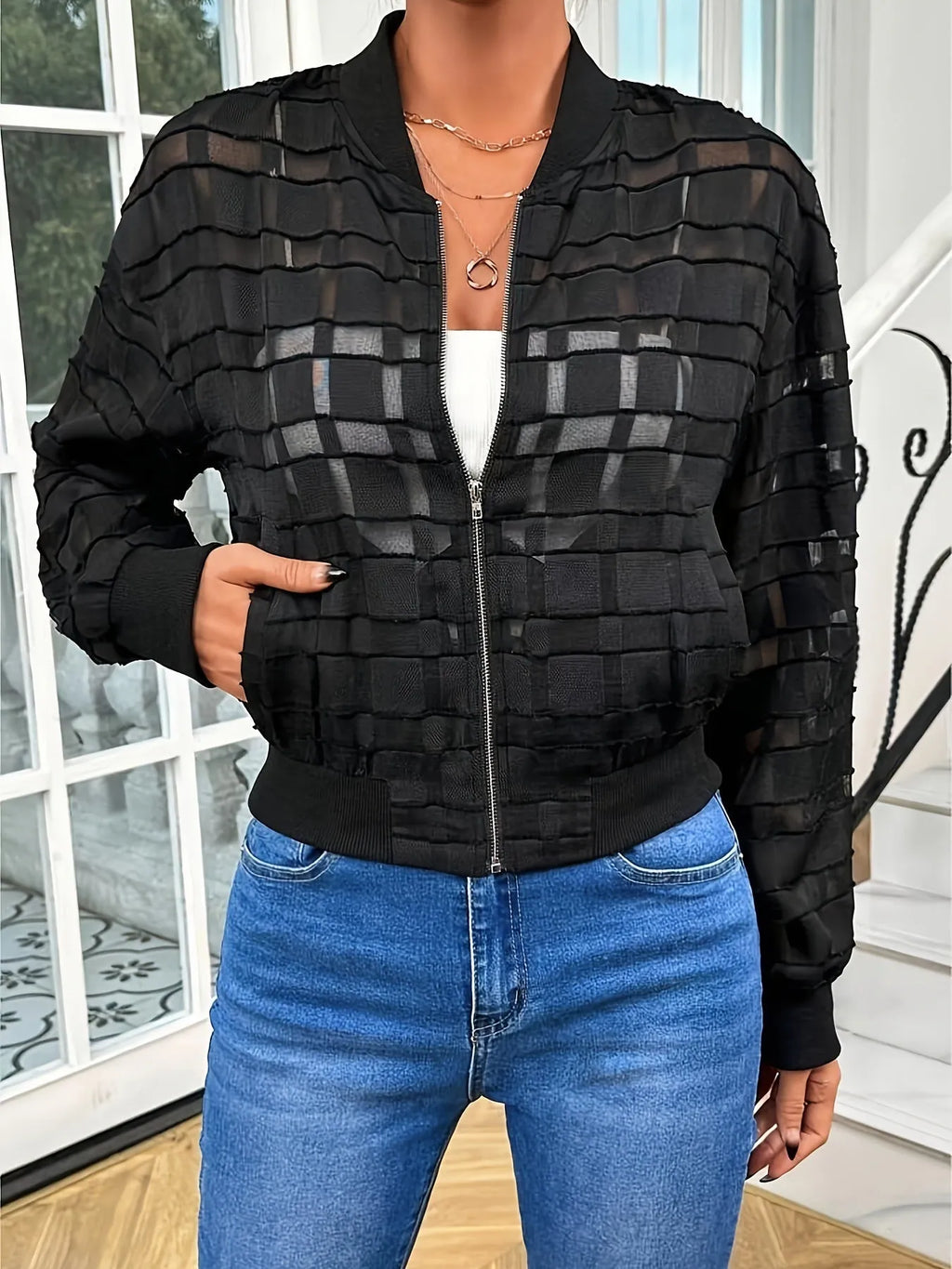 Black women's casual jacket with geometric pattern and semi-transparent thread detail, zip front.