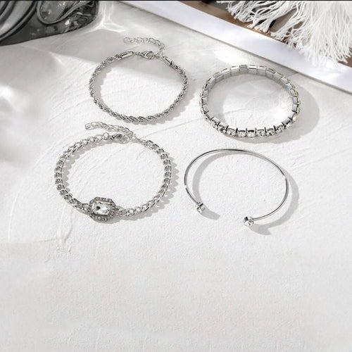 Four geometric retro-style alloy bracelets with square diamond design in gold and silver colours