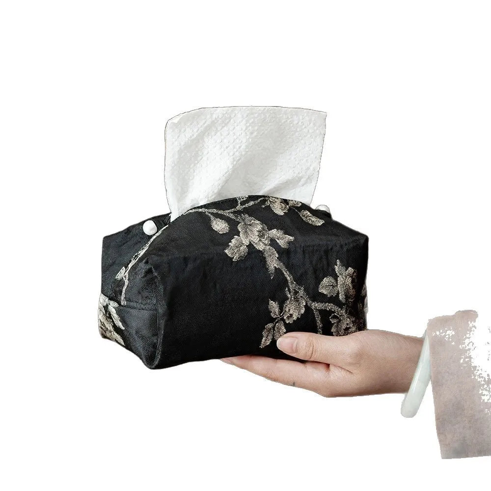White Chinese brocade fabric tissue box with embroidered plum blossoms, shown with and without a pearl buckle clasp.