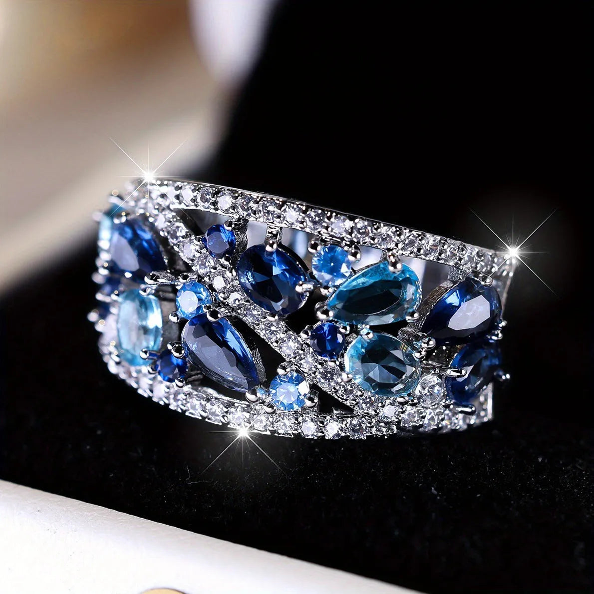 Women's hollow round copper fashion ring showing gold and platinum finishes with sapphire blue and white diamond accent options