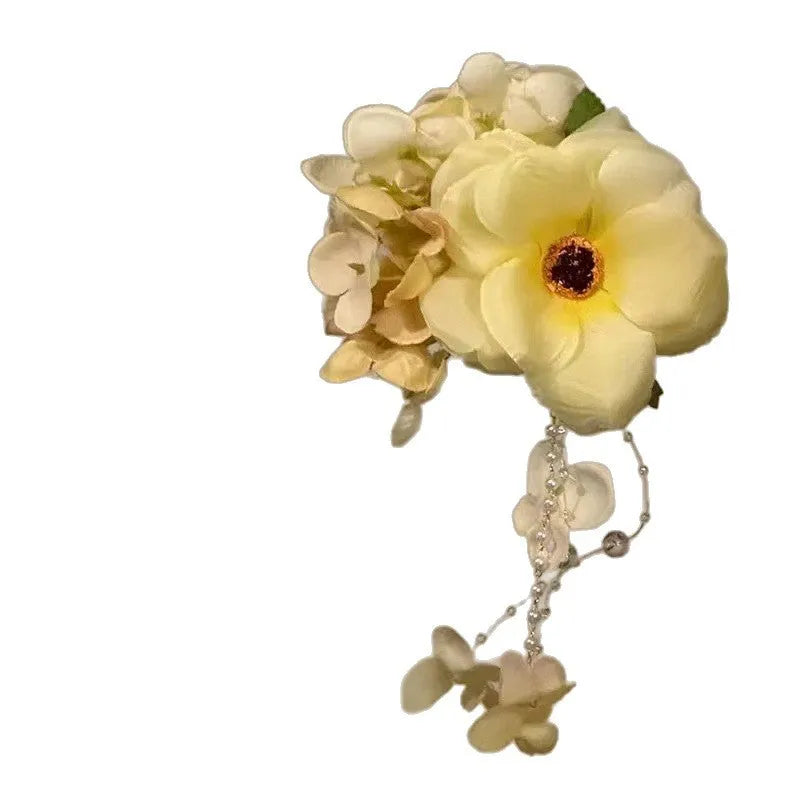 Yellow and purple floral tassel side clip hair accessory for women.