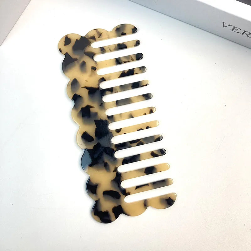 Acetate board geometric wave hairdressing comb for women in pink colour, showing wave shape and lightweight construction