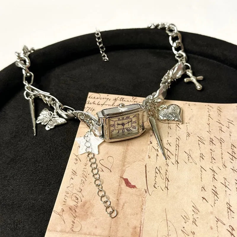 Dark multi-layer cross necklace with twin clavicle chain and textured hemp flowers chain on model