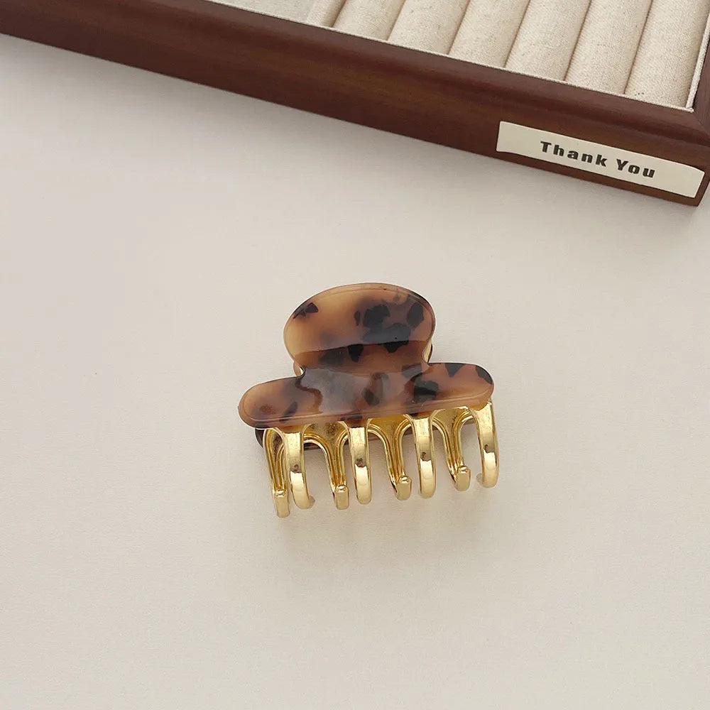 Acetate hair barrettes with metal grip closure in leopard print, beige, white and ink colours