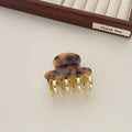 Acetate hair barrettes with metal grip closure in leopard print, beige, white and ink colours