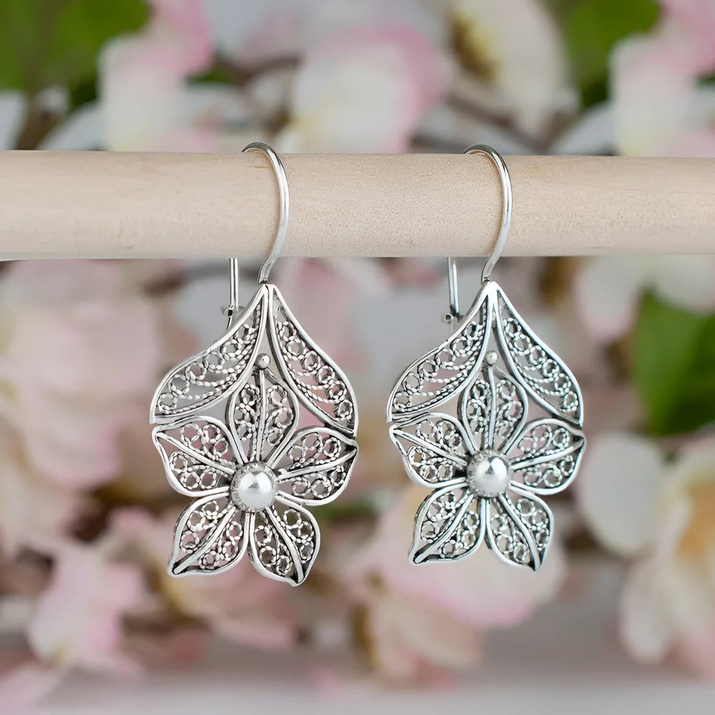 Silver-colour alloy women's earrings with a hollow retro flower leaf shape.