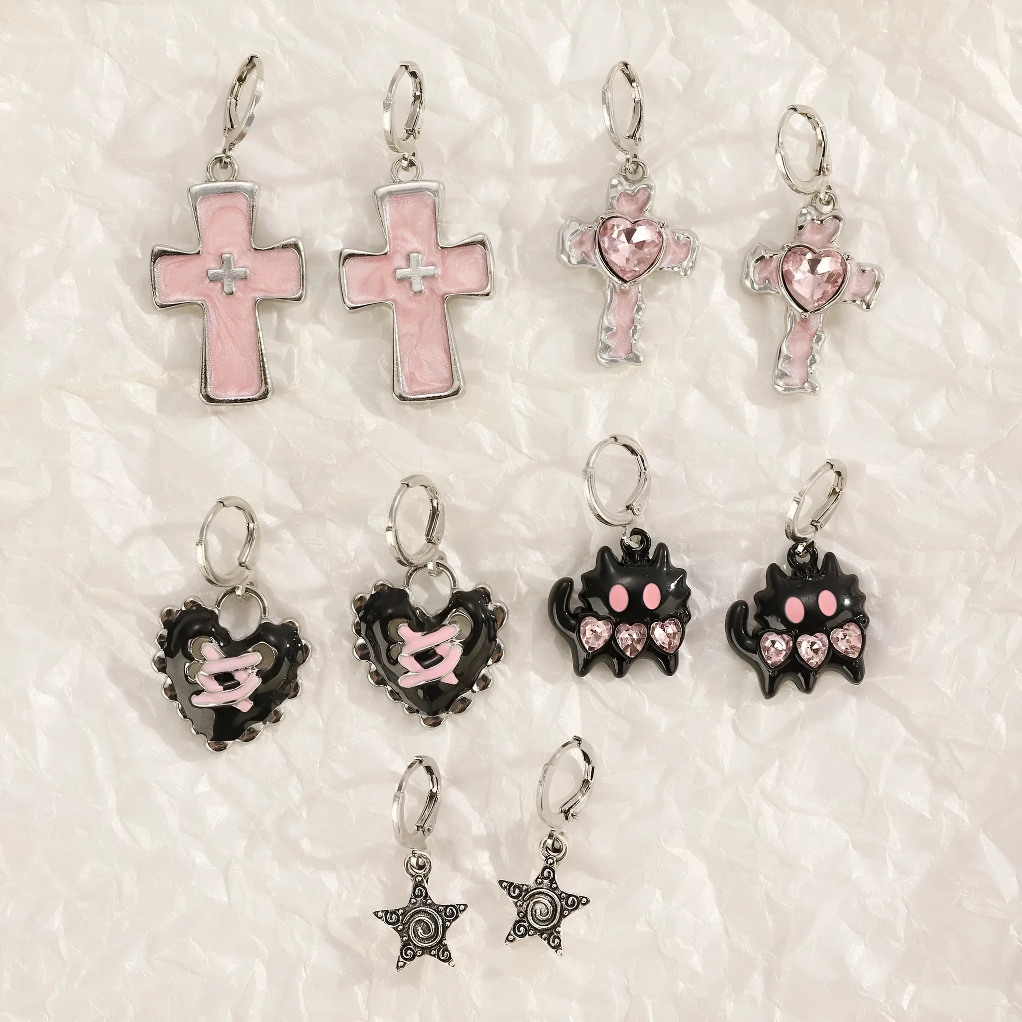 Women's classic alloy earrings showing cross, heart, and animal designs in white, black, and silver colours