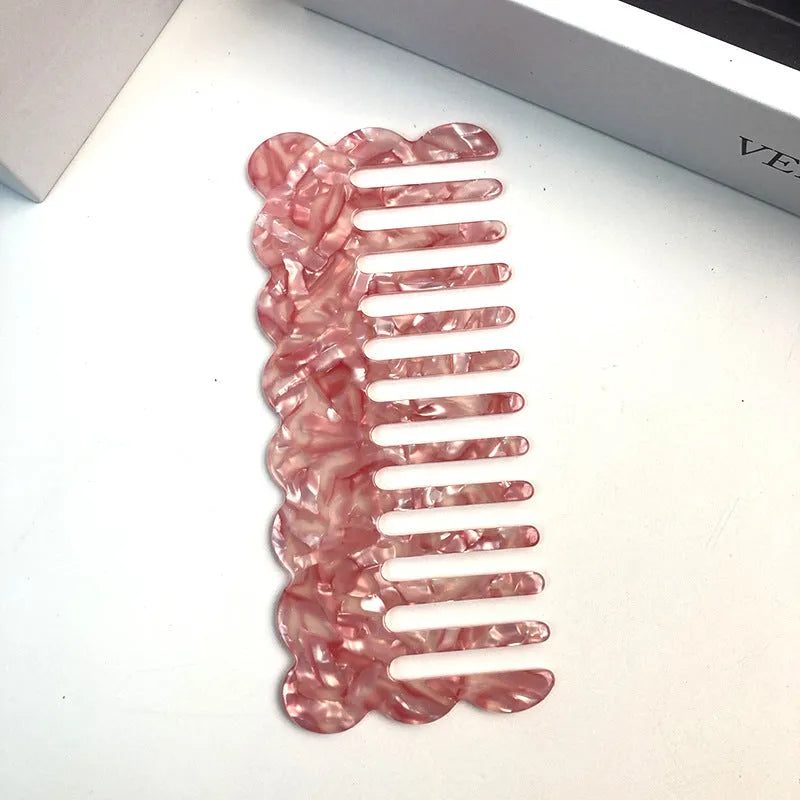Acetate board geometric wave hairdressing comb for women in pink colour, showing wave shape and lightweight construction