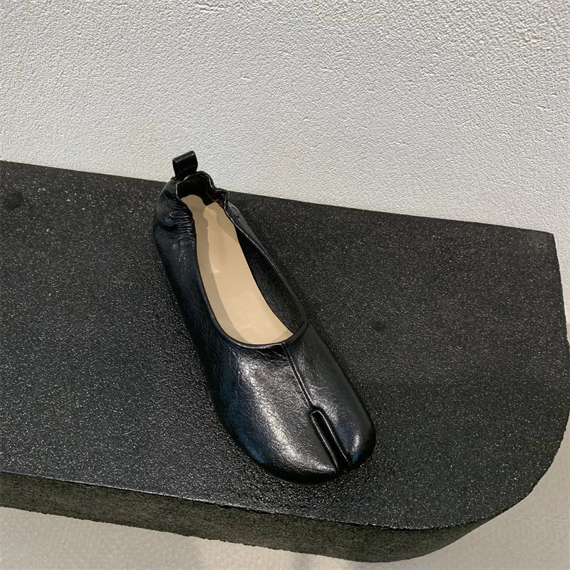 Women's apricot coloured chunky low heel pumps with round toe and split toe horseshoe design detail.