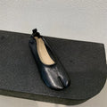 Women's apricot coloured chunky low heel pumps with round toe and split toe horseshoe design detail.