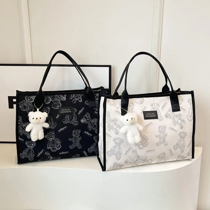 Women's black canvas tote bag with rhombus pattern showing sandwich pocket organisation interior