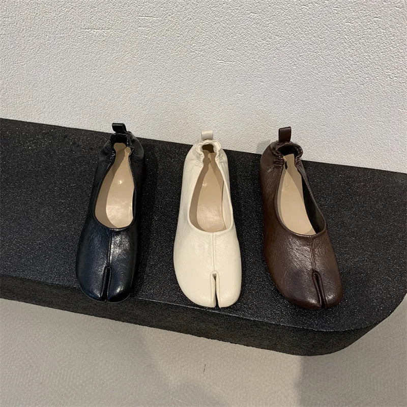 Women's apricot coloured chunky low heel pumps with round toe and split toe horseshoe design detail.
