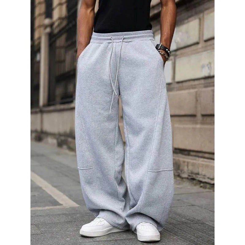 Men's high-waisted straight-leg casual trousers in a neutral colour, showing the cropped length and elasticated fit.