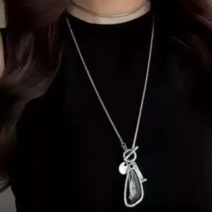 Long geometric plaid alloy pendant on a snake bones chain necklace in blue, champagne, or grey.
