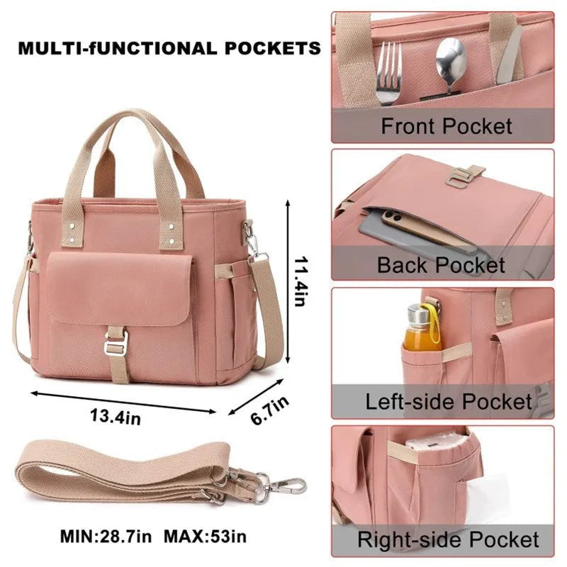 Cube-shaped pink Oxford cloth picnic bag with a removable shoulder strap and side pocket, shown on a wooden table.