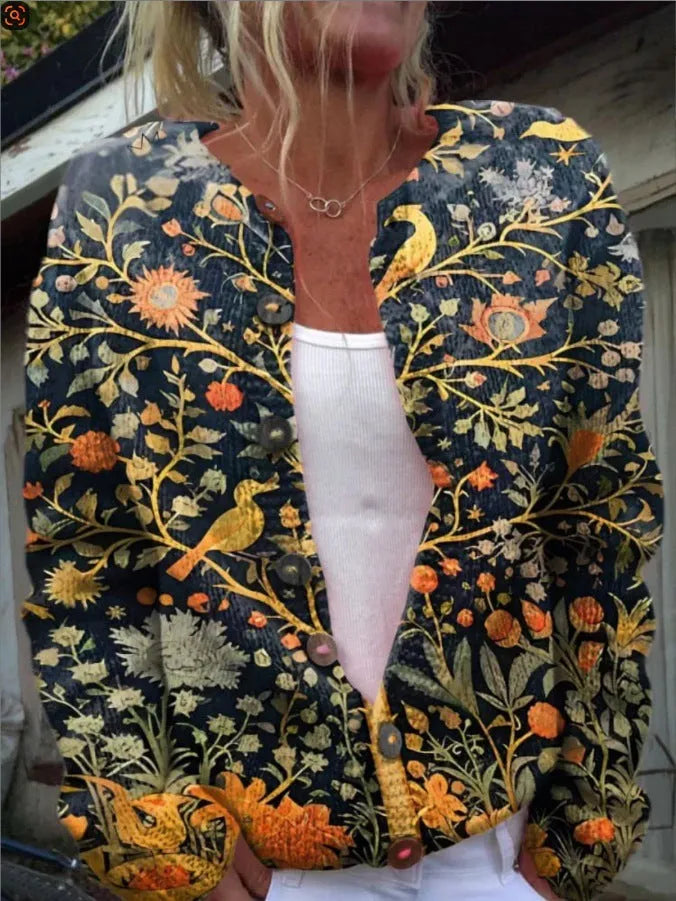 A woman's long-sleeve black top with a colourful 3D digital print pattern, suitable for Halloween.