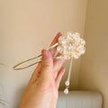 Close-up of a retro U-shaped alloy hairpin with a purple peony flower and tassel design.