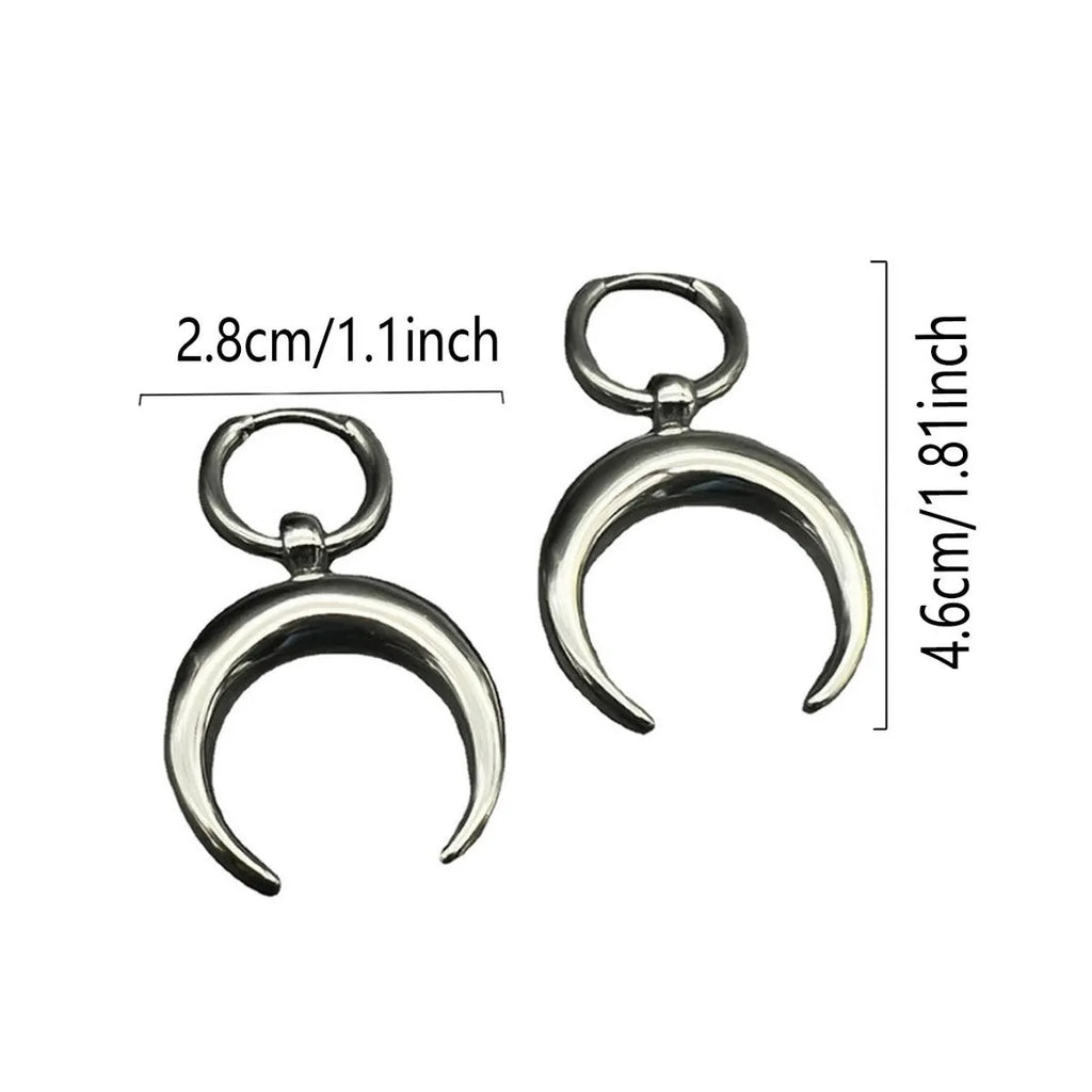 A pair of large silver geometric hoop earrings with a detailed Gothic moon motif, shown as clip-ons.