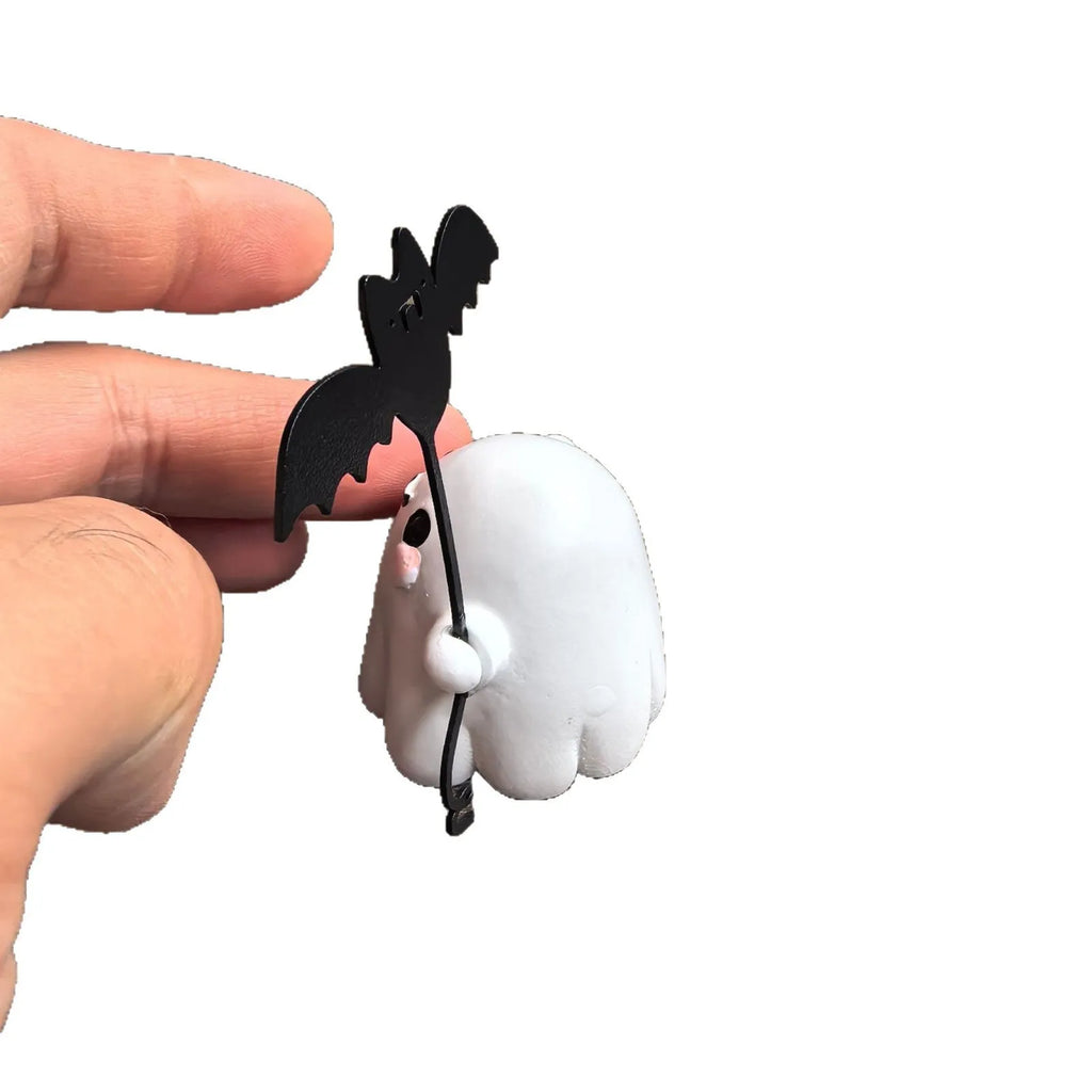 Small hand-painted resin statue of a ghost walking a dog and holding a bat, a miniature Halloween ornament.