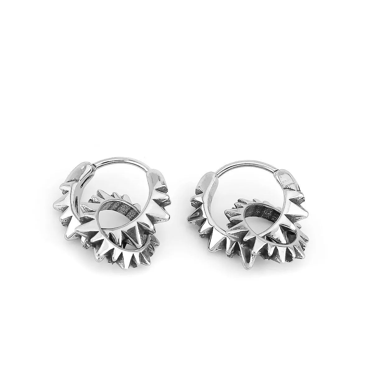 A pair of polished stainless steel round ring earrings in a steel colour finish on a plain background.