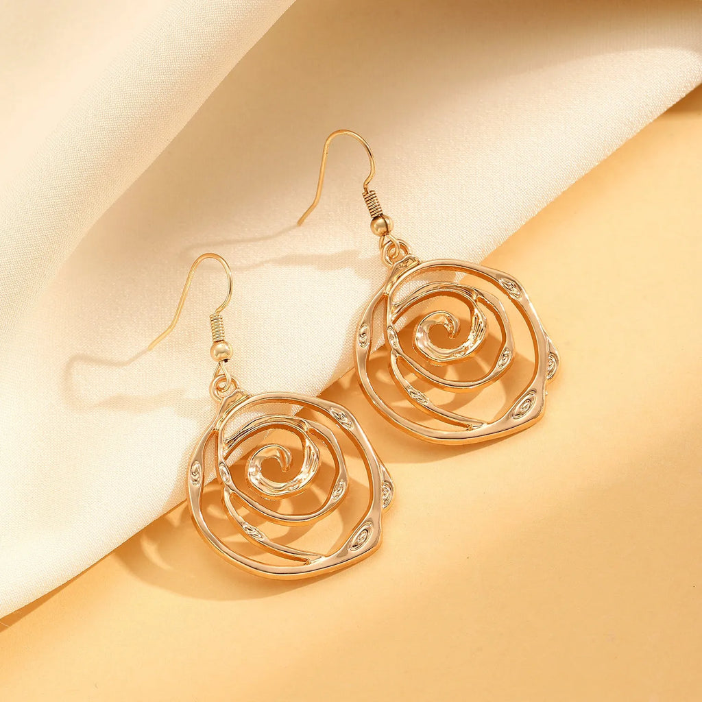 Spiral donut jewellery set showing necklace, bracelet and ear hooks in gold or silver geometric circle design