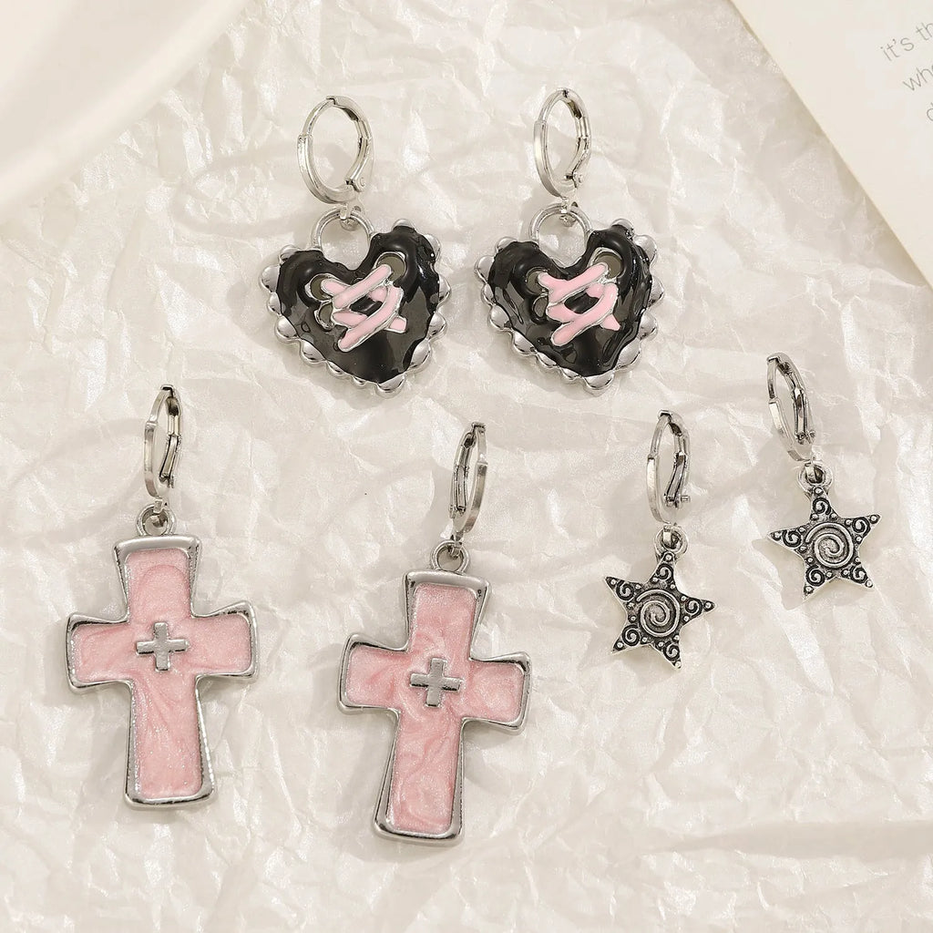 Women's classic alloy earrings showing cross, heart, and animal designs in white, black, and silver colours