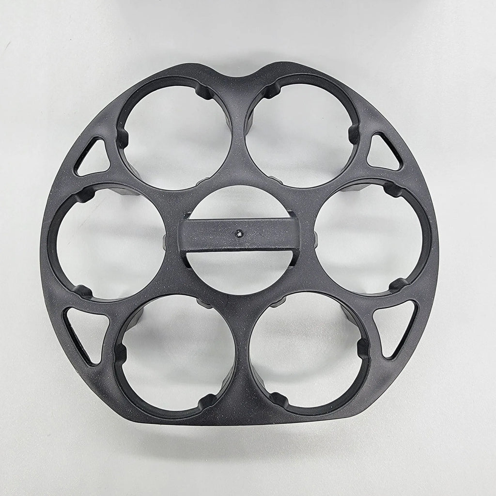 Black plastic egg holder cooking basket rack on a kitchen counter.
