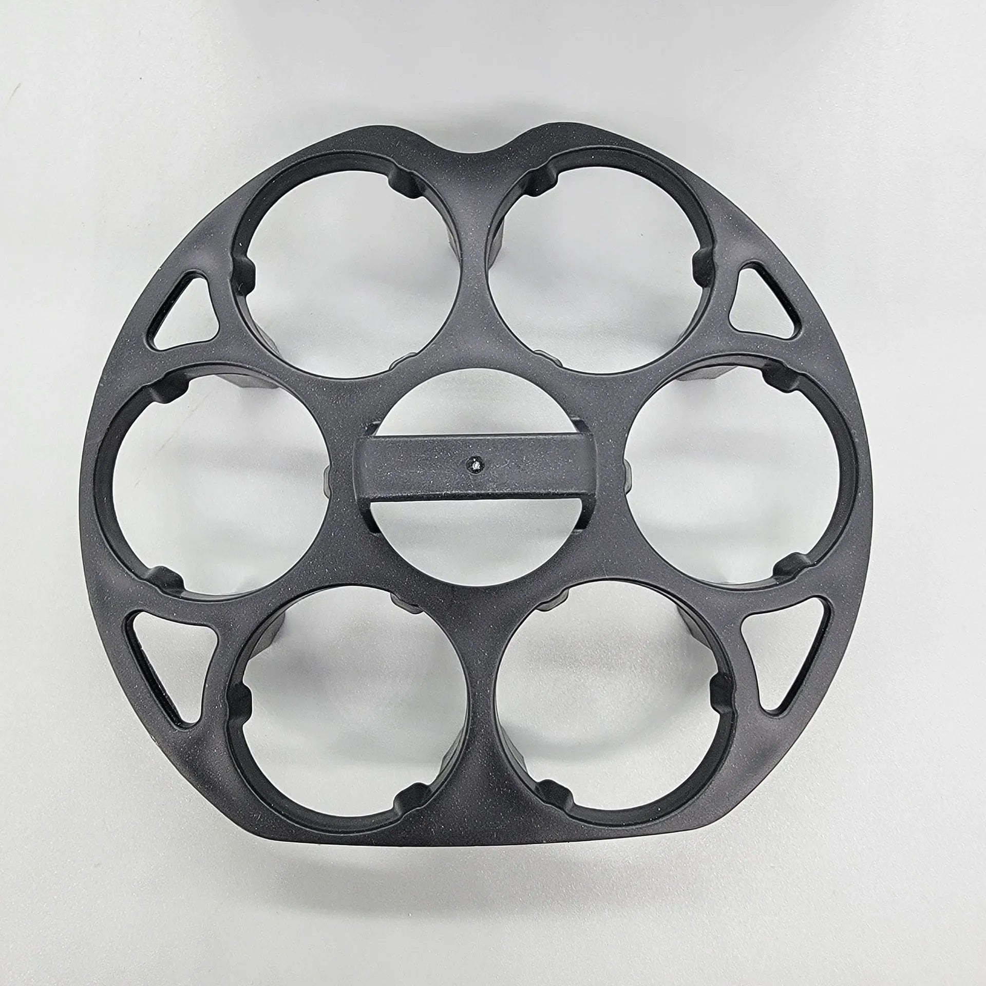 Black plastic egg holder cooking basket rack on a kitchen counter.
