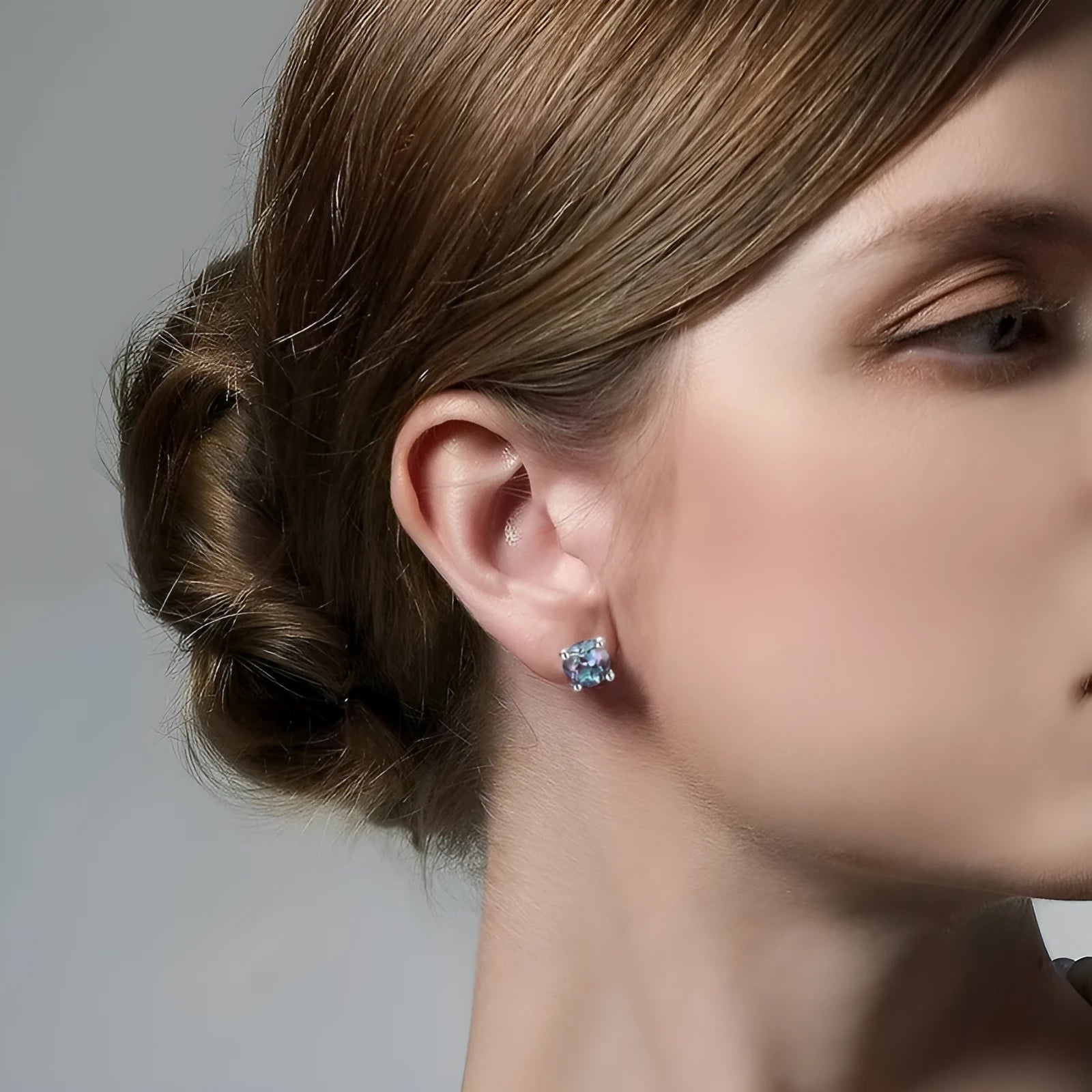 Simple geometric stud earrings with a round cultivate alexandrite stone on a 925 silver post.